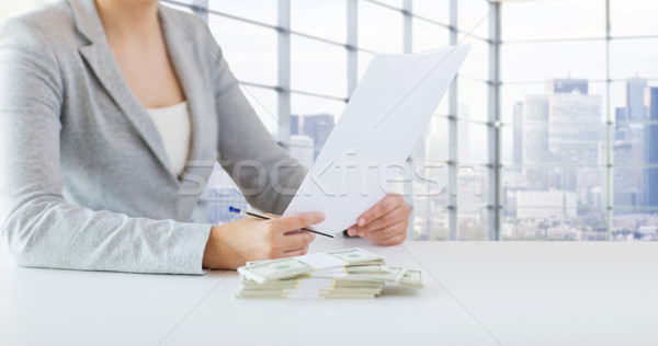 close up of female hands with money and tax report Stock photo © dolgachov