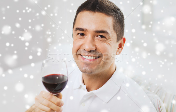 happy man drinking red wine from glass at home Stock photo © dolgachov