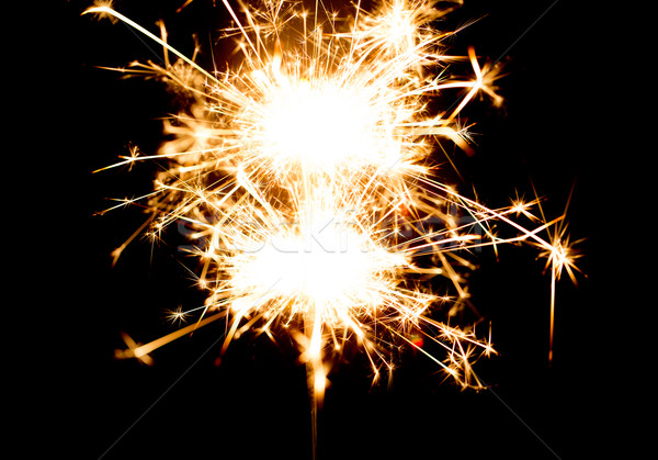 sparkler or bengal light burning over black Stock photo © dolgachov