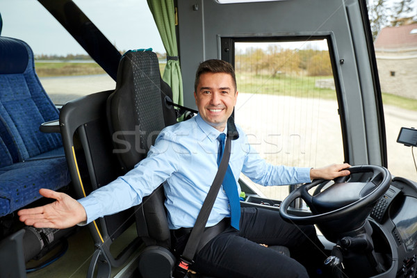 happy driver inviting on board of intercity bus Stock photo © dolgachov