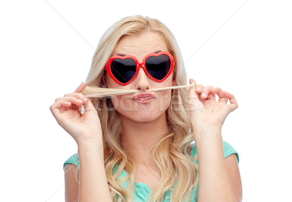 Stock photo: happy young woman making mustache with her hair