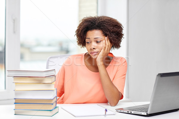 bored african american woman doing homework home Stock photo © dolgachov