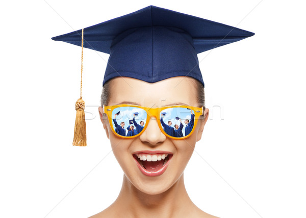 happy teenage girl in shades and mortarboard hat Stock photo © dolgachov