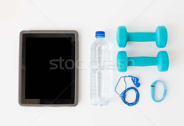 tablet pc, dumbbells, earphones and bottle Stock photo © dolgachov