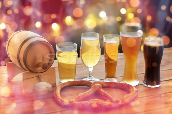 close up of beer glasses, barrel and pretzel Stock photo © dolgachov