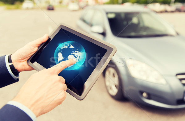 close up of male hands with tablet pc and car Stock photo © dolgachov