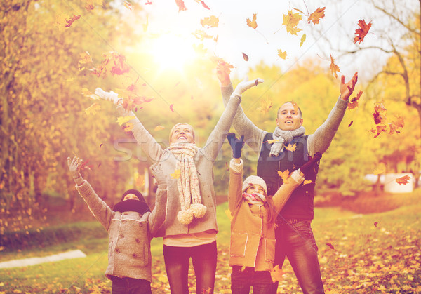 happy family playing with autumn leaves in park Stock photo © dolgachov