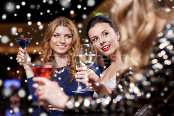 Stock photo: happy women with drinks at night club