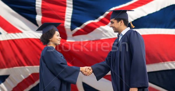 happy students or bachelors greeting each other Stock photo © dolgachov