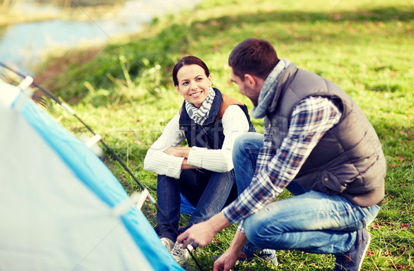 happy couple setting up tent outdoors Stock photo © dolgachov