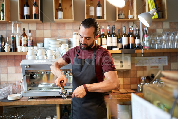 barista with holder and tamper making at coffee Stock photo © dolgachov