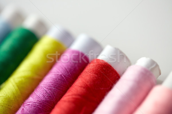 row of colorful thread spools on table Stock photo © dolgachov