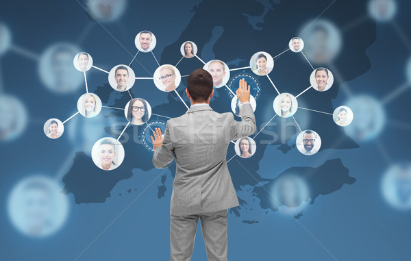 businessman using virtual screen with contacts Stock photo © dolgachov