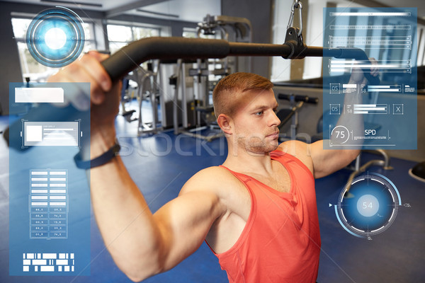 man flexing muscles on cable machine gym Stock photo © dolgachov
