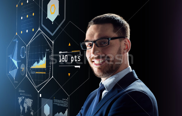 smiling businessman in glasses over black Stock photo © dolgachov