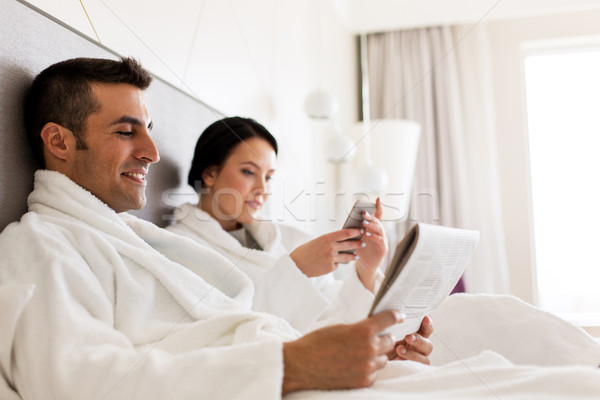 Stock photo: happy couple in bed at home or hotel room