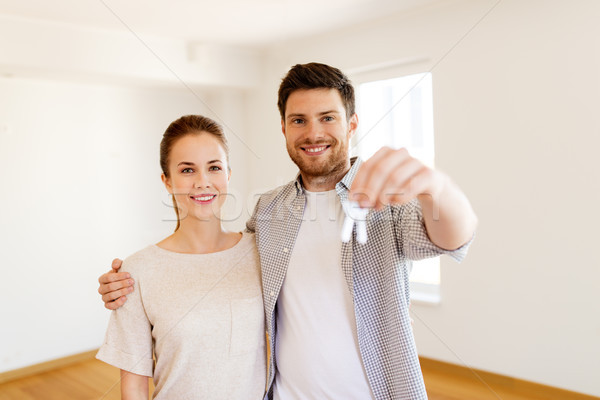 Stock photo: happy couple with keys of new home