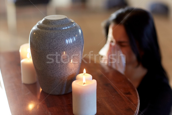 woman with cremation urn at funeral in church Stock photo © dolgachov