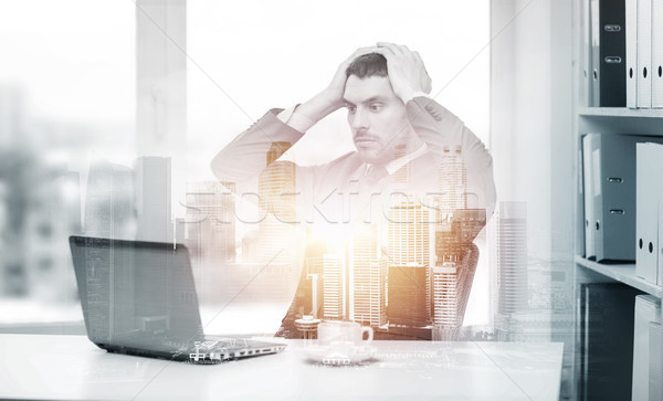 stressing businessman with laptop at office Stock photo © dolgachov