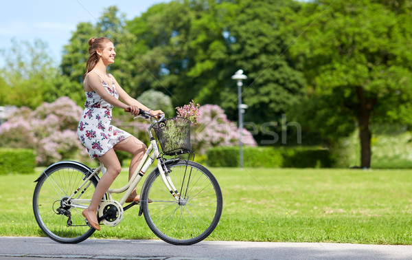 happy woman riding fixie bicycle in summer park Stock photo © dolgachov