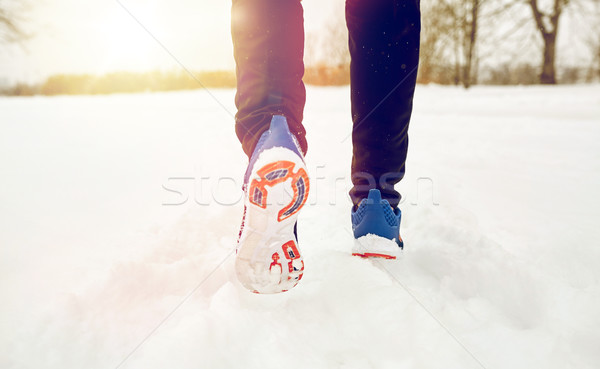 close up of feet running along snowy winter road Stock photo © dolgachov