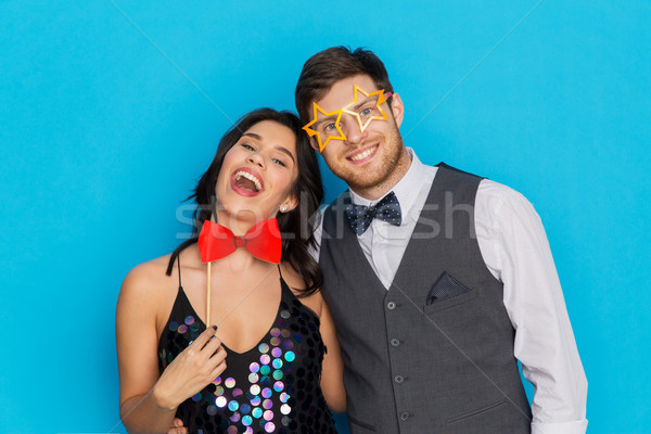 happy couple with party props having fun Stock photo © dolgachov