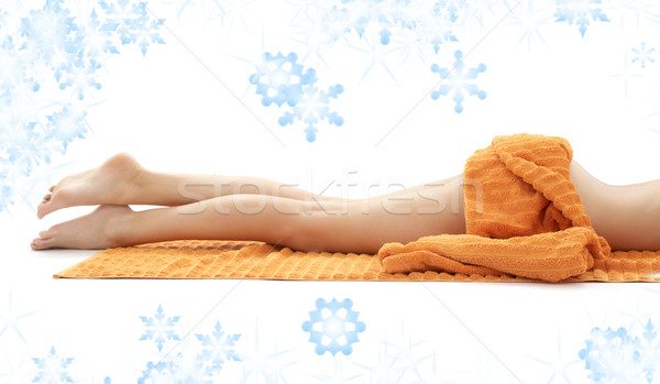 legs of relaxed lady with orange towel Stock photo © dolgachov