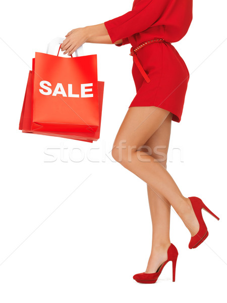 woman on high heels holding shopping bags Stock photo © dolgachov