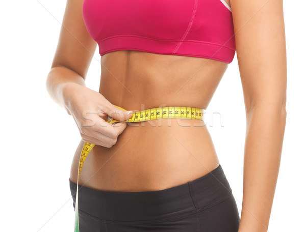 trained belly with measuring tape Stock photo © dolgachov