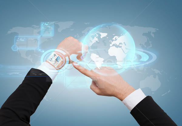 businessman pointing to virtual watch at his hand Stock photo © dolgachov