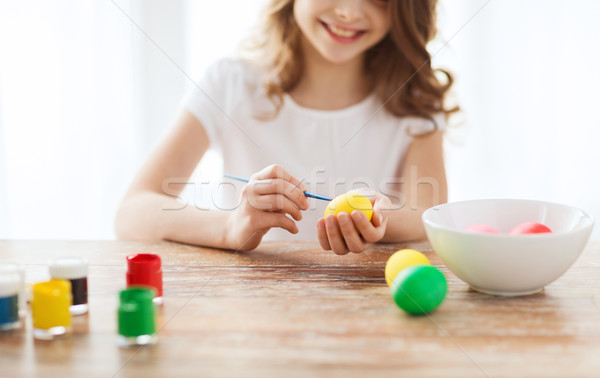 close up of girl coloring eggs for easter Stock photo © dolgachov