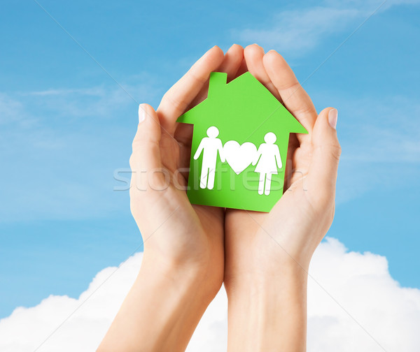 hands holding green house with family Stock photo © dolgachov