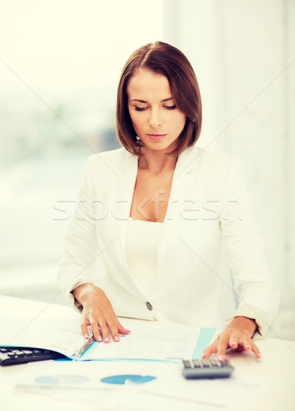 businesswoman working with calculator in office Stock photo © dolgachov