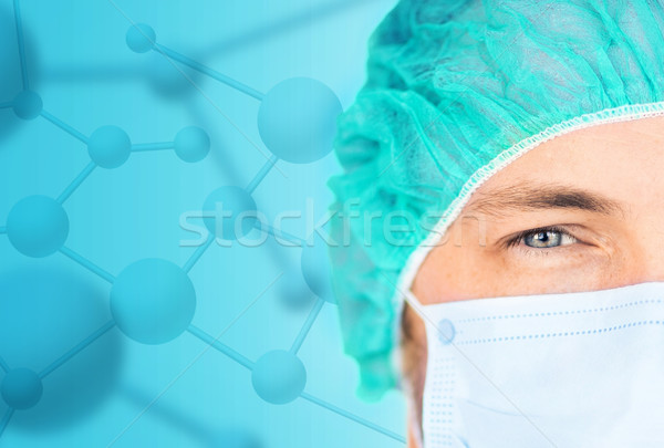close up of surgeon in medical cap and mask Stock photo © dolgachov