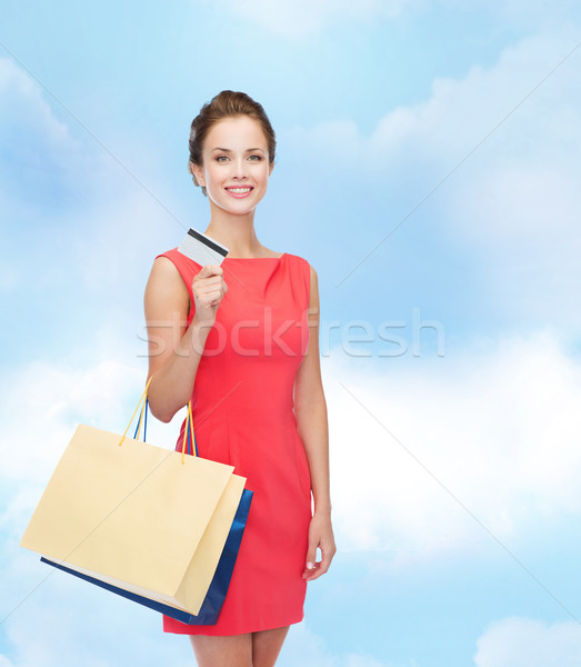 smiling woman with shopping bags and plastic card Stock photo © dolgachov