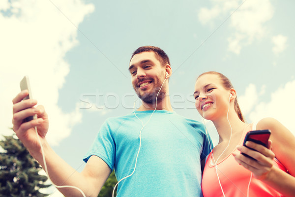 Zwei lächelnd Menschen Smartphones Freien Fitness Stock foto © dolgachov