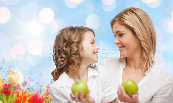 happy mother and daughter with green apples Stock photo © dolgachov
