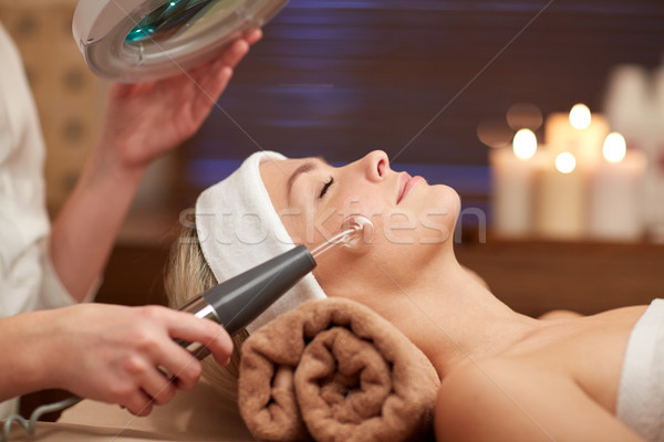 Stock photo: close up of young woman having face massage in spa