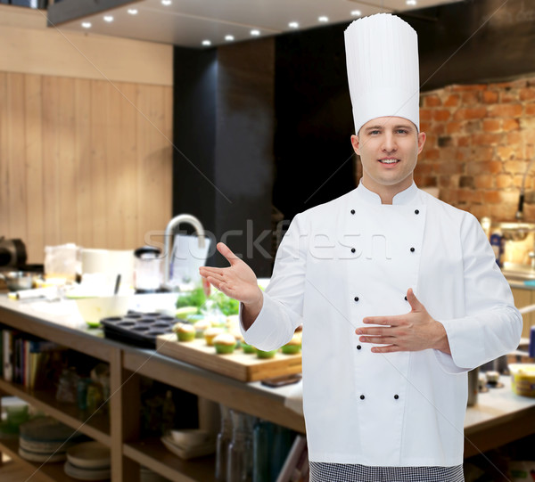 happy male chef cook inviting Stock photo © dolgachov