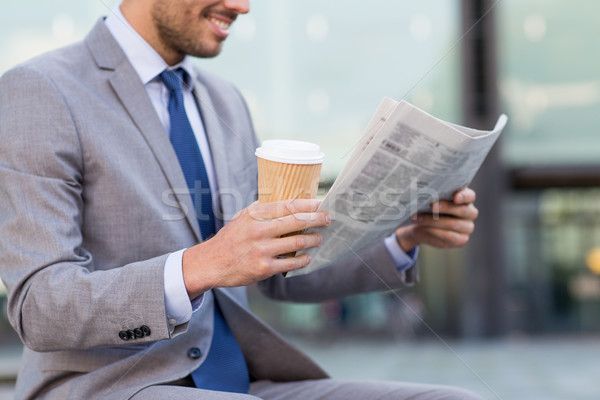 close up of smiling businessman reading newspaper Stock photo © dolgachov