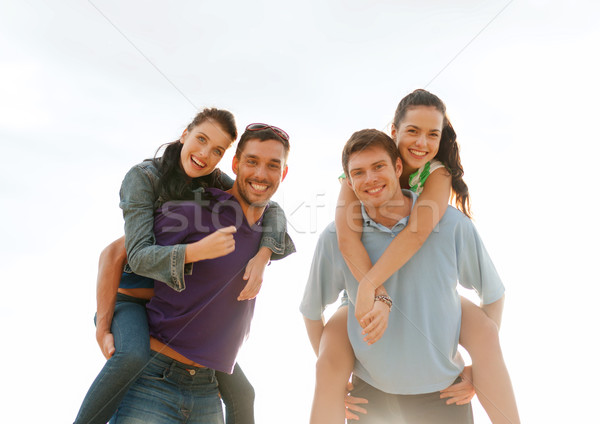 group of happy friends having fun outdoors Stock photo © dolgachov