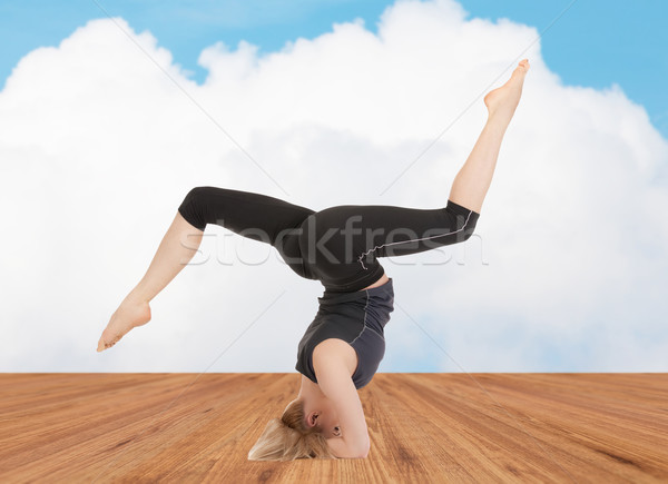 happy young woman doing yoga exercise Stock photo © dolgachov