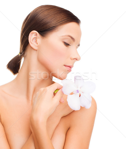 relaxed woman with orchid flower Stock photo © dolgachov