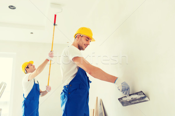 group of builders with tools indoors Stock photo © dolgachov