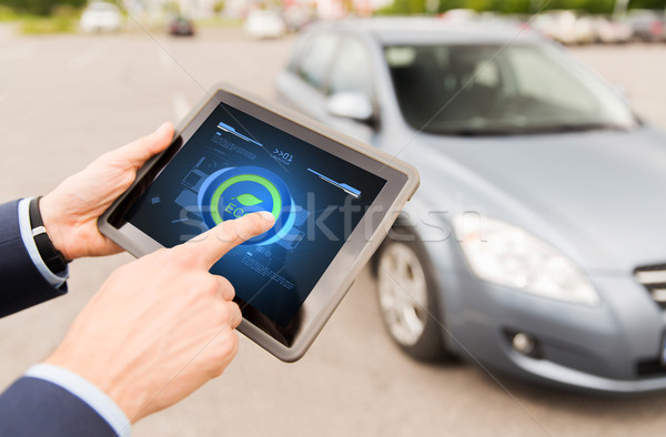 close up of male hands with tablet pc and car Stock photo © dolgachov
