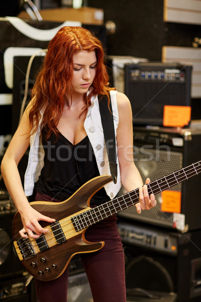 musician or customer with guitar at music store Stock photo © dolgachov