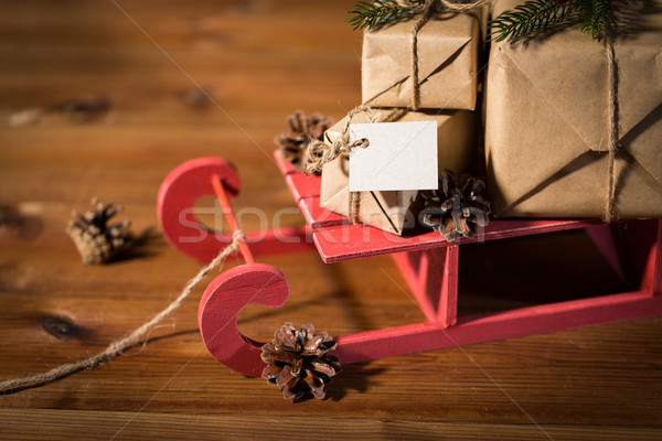 close up of christmas gifts with note on sleigh Stock photo © dolgachov