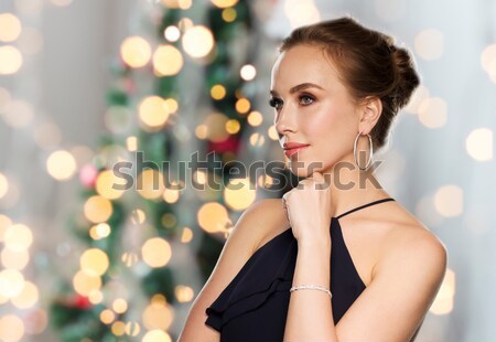 beautiful sexy woman in red dress over lights Stock photo © dolgachov