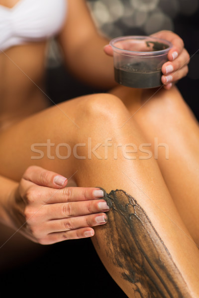 close up of woman applying therapeutic mud in spa Stock photo © dolgachov