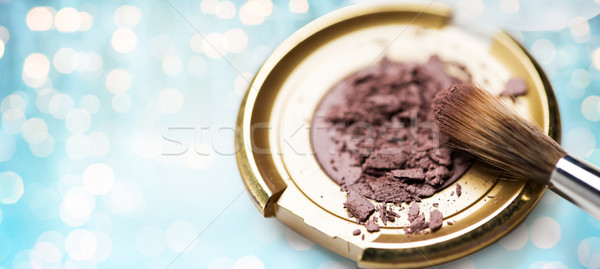 close up of makeup brush and eyeshadow over lights Stock photo © dolgachov